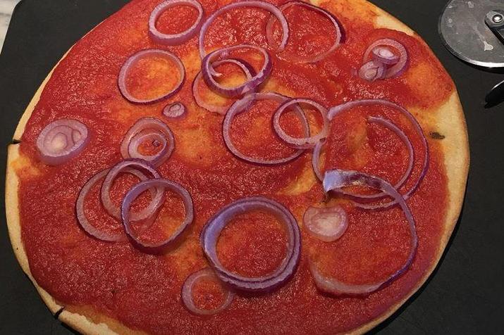Vegan served pizza topped with just raw onions (Facebook Mary Nesbitt-Larking)