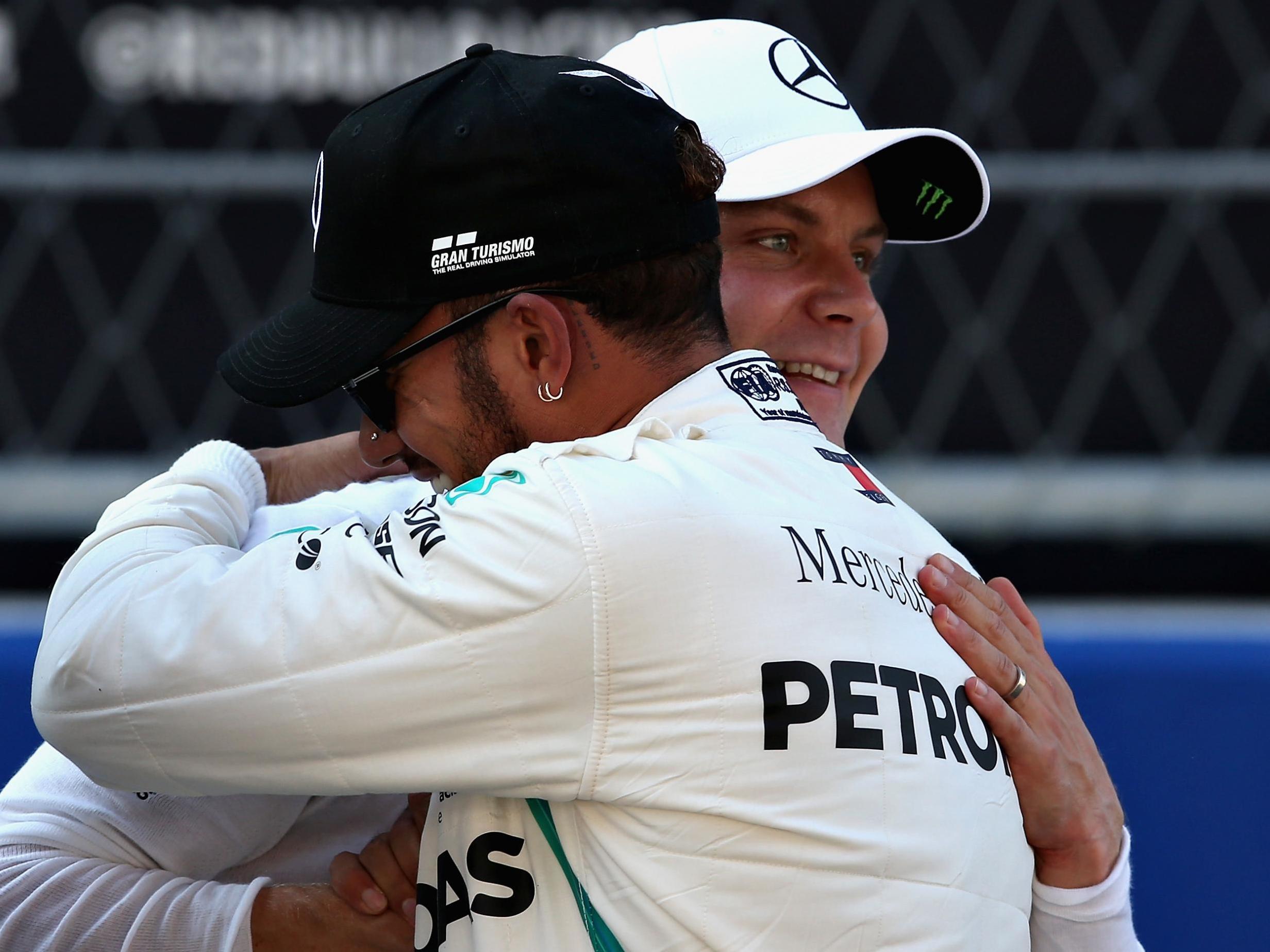 Hamilton congratulates his partner after securing pole