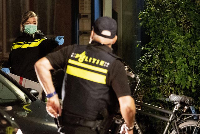 Officers inspect a house associated with an alleged terrorist in Holland