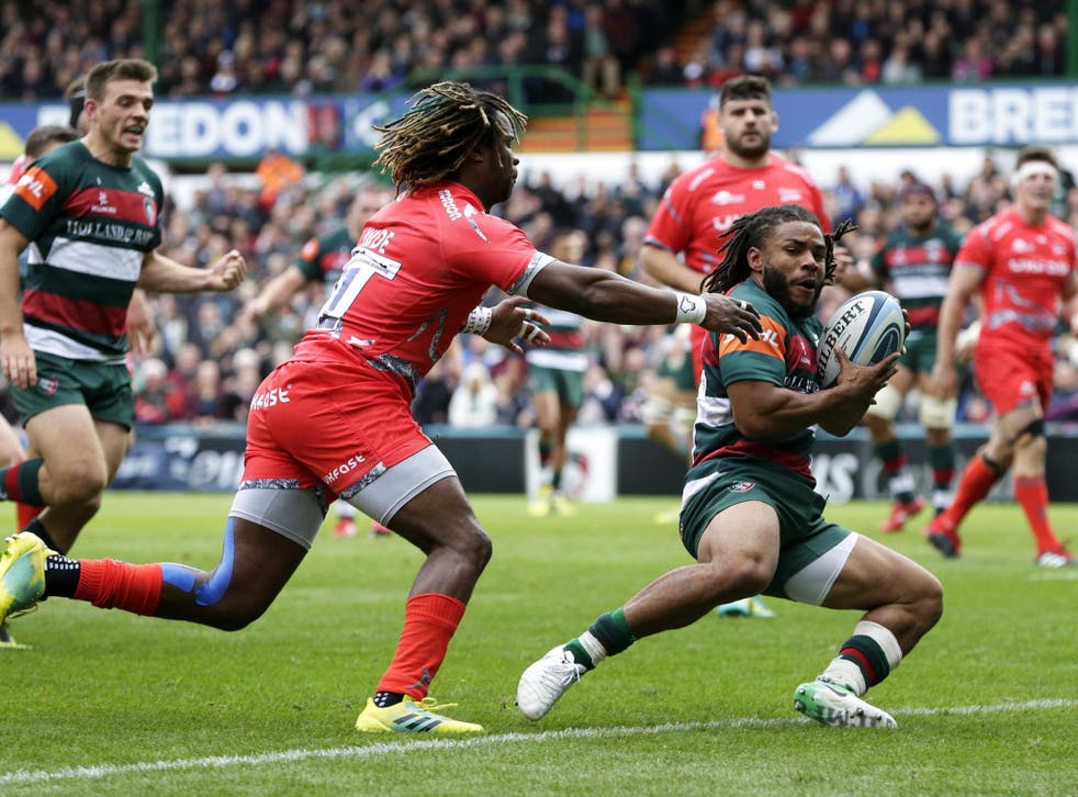 Kyle Eastmond holds off Marland Yarde to score a try for Leicester