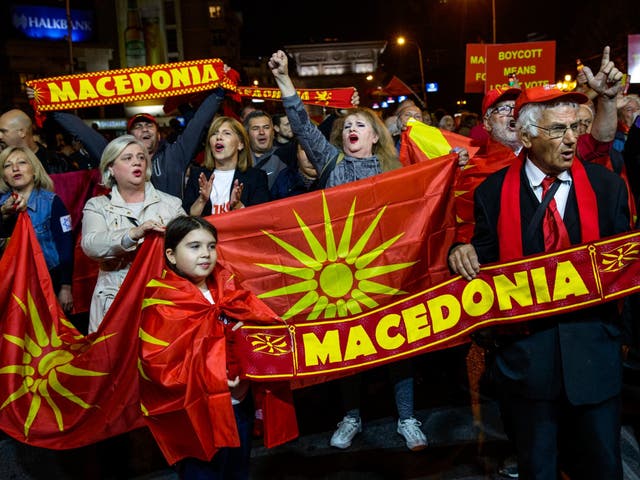 Referendum opponents celebrate the low turnout outside Macedonia's parliament in Skopje