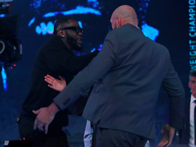 Deontay Wilder pushes Tyson Fury during the press conference