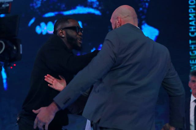 Deontay Wilder pushes Tyson Fury during the press conference