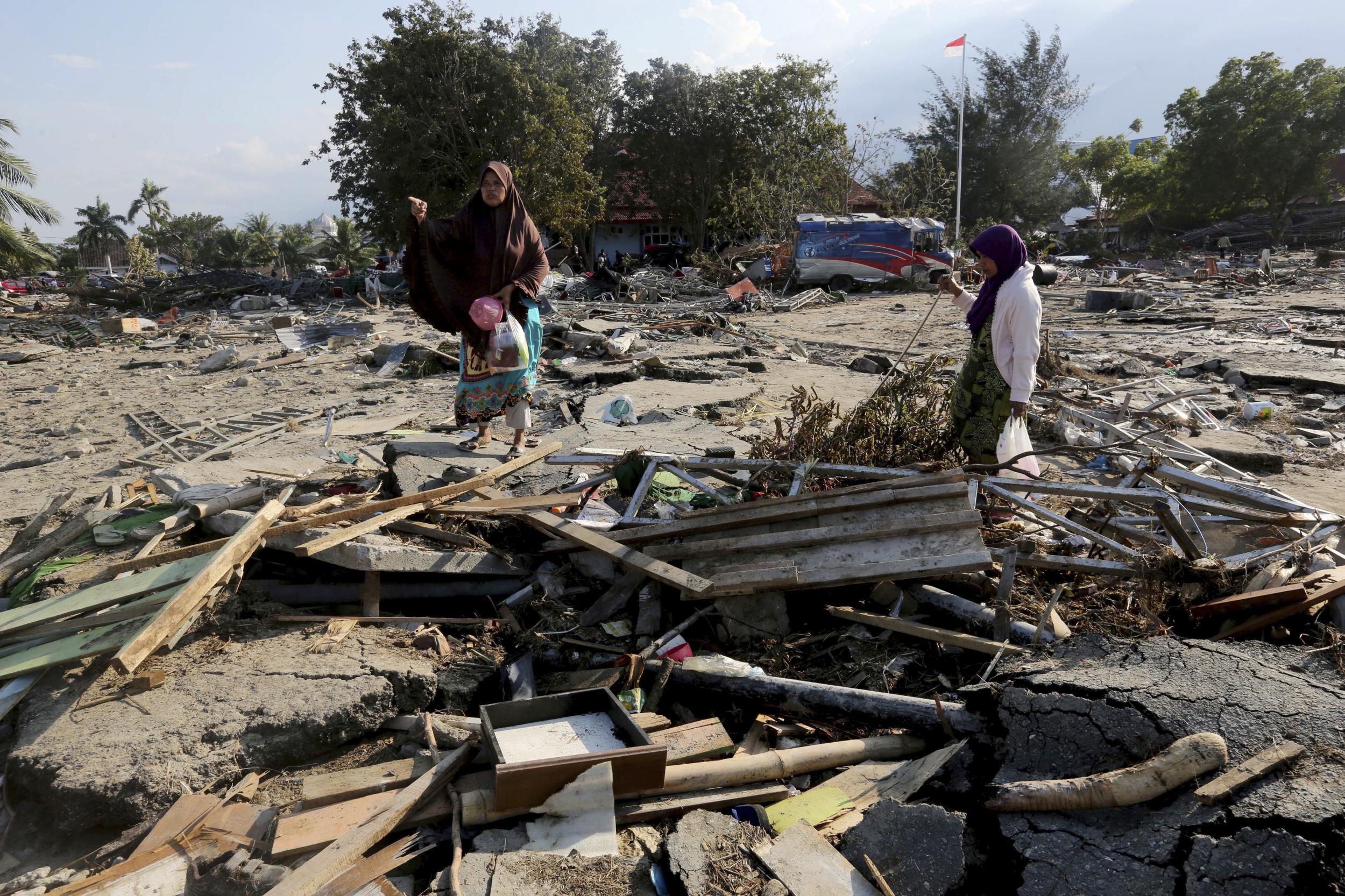 Residents survey a wrecked area (AP )