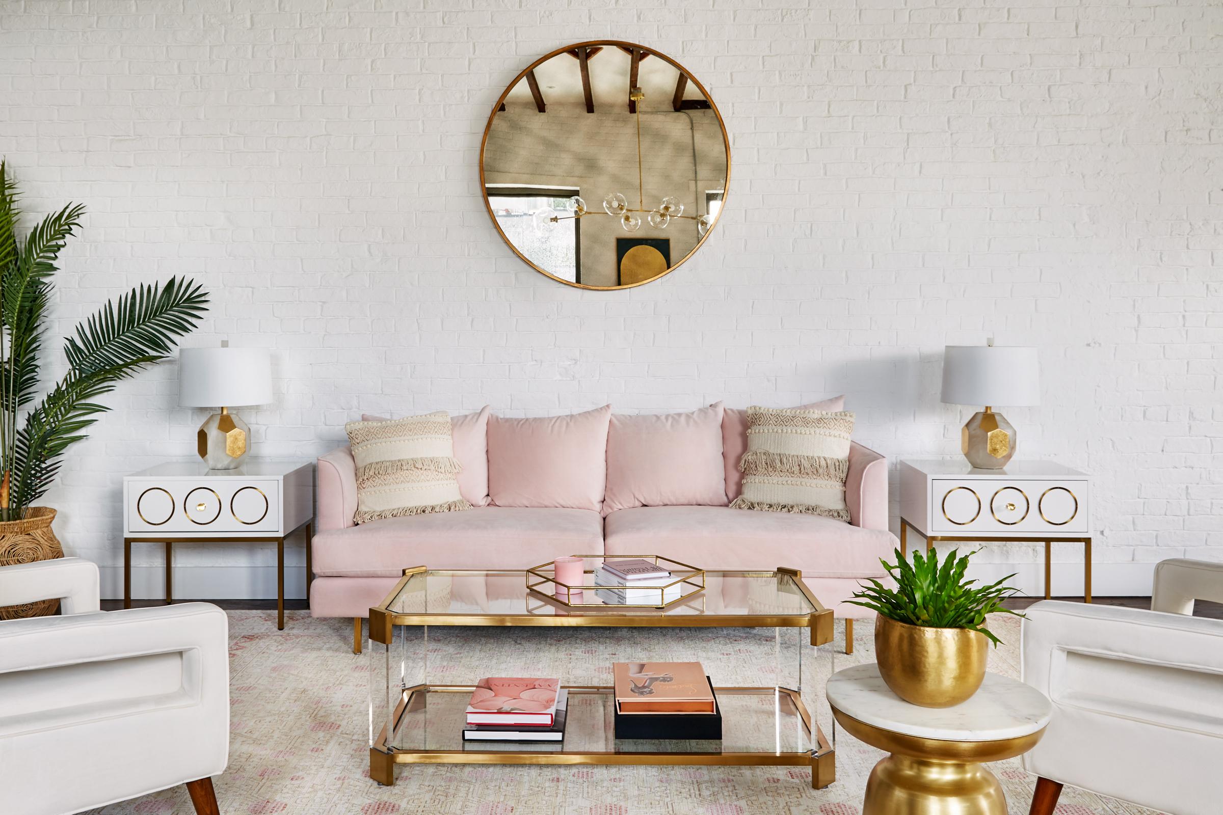 The millennial-pink couch is the perfect spot for photos (Village Marketing)