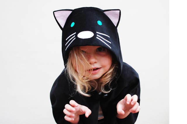 This cute cat cape has a hood for chillier temperatures