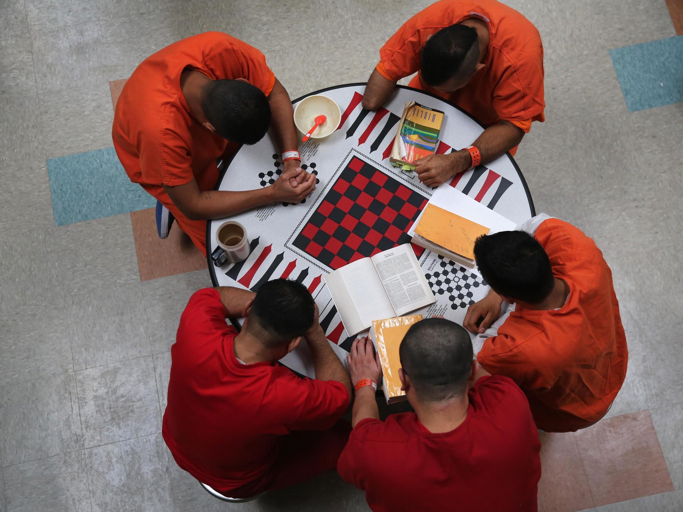 Immigrant detainees pray during a prayer group in a general population block at the Adelanto Detention Facility (Photo by John Moore/Getty Images)