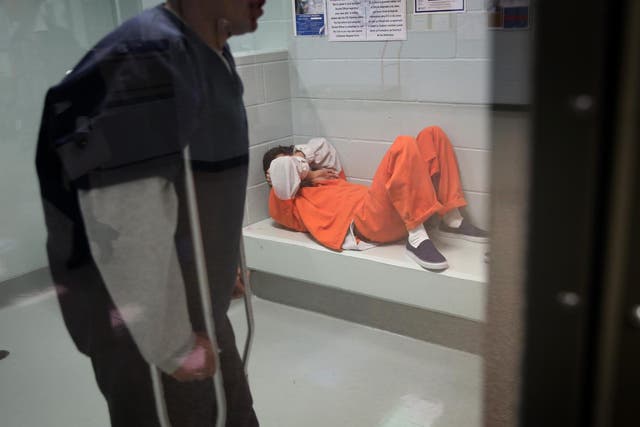 Immigrants wait in a processing cell at the Adelanto Detention Facility on November 15, 2013 in Adelanto, California.