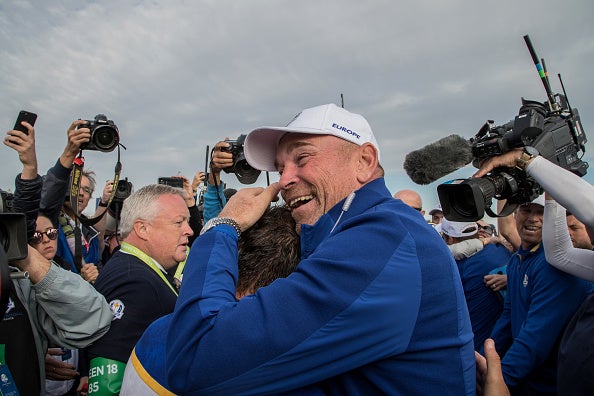 Thomas Bjorn hugs Francesco Molinari after he secures the winning point