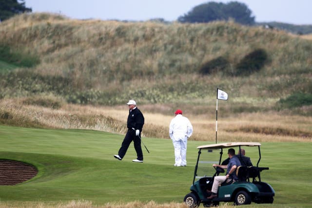 Donald Trump walks off the 4th green while playing at Turnberry golf club