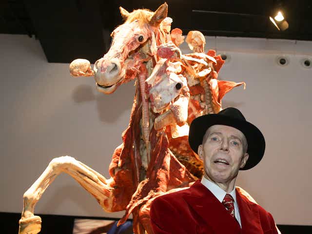 German anatomist and inventor of the plastination technique Gunther von Hagens poses next to an artwork entitled 'Rider'