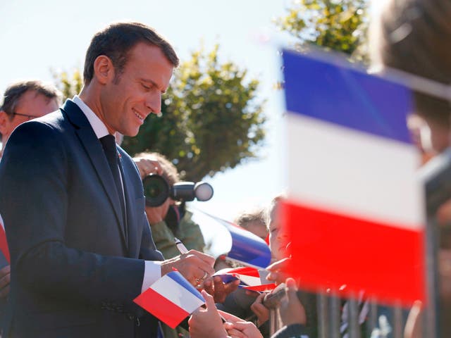 French president Emmanuel Macron signs autographs after paying his respects at the grave of former leader Charles de Gaulle in Colombey-les-Deux-Eglises, France, 4 October