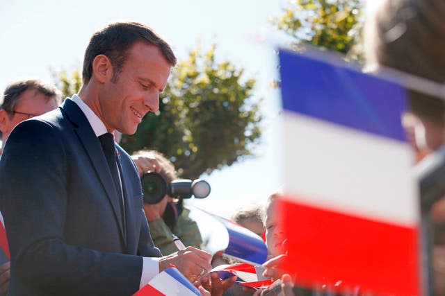French president Emmanuel Macron signs autographs after paying his respects at the grave of former leader Charles de Gaulle in Colombey-les-Deux-Eglises, France, 4 October