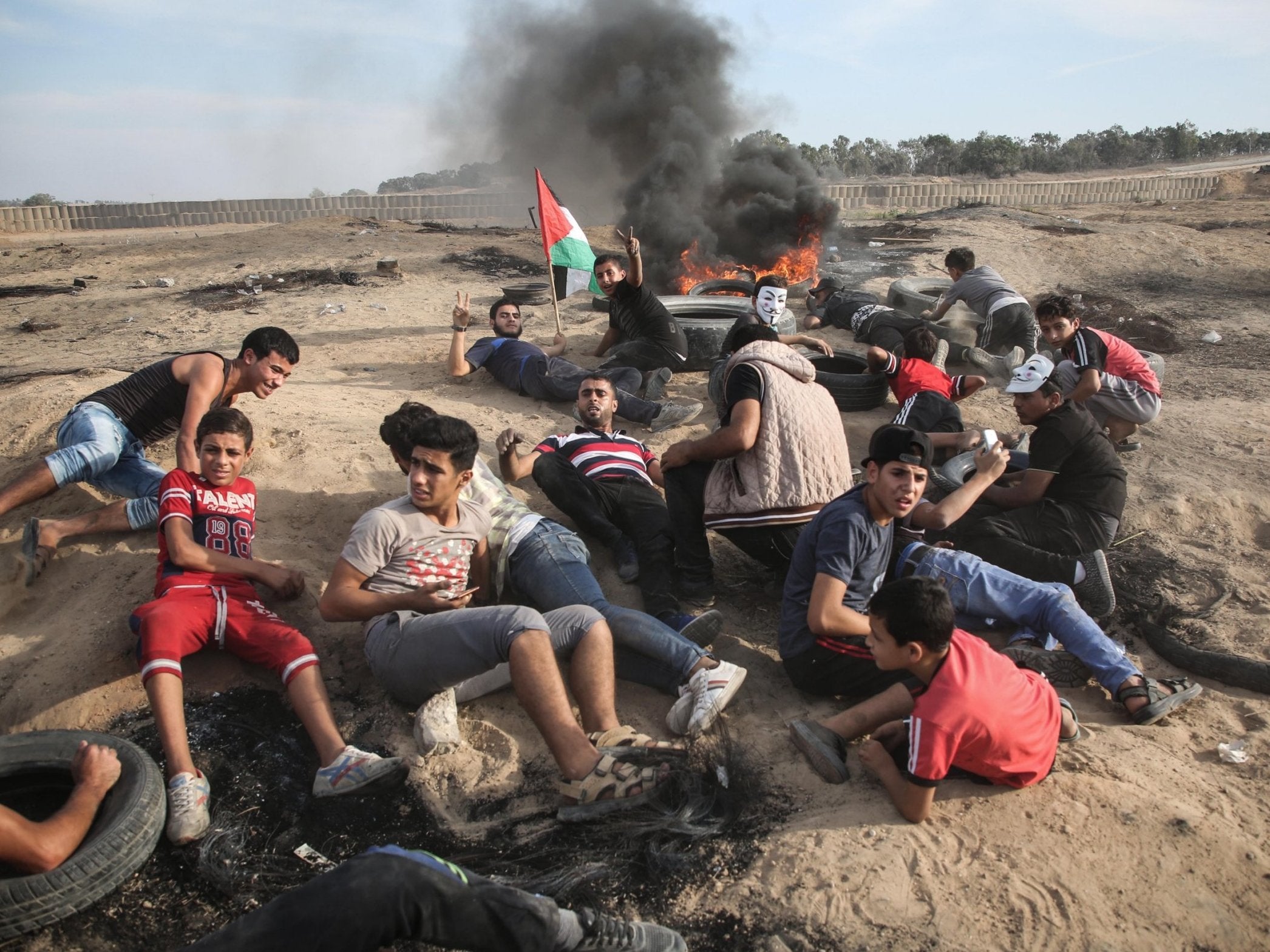 Palestinians take cover at protest on the Gaza-Israel border on 5 October