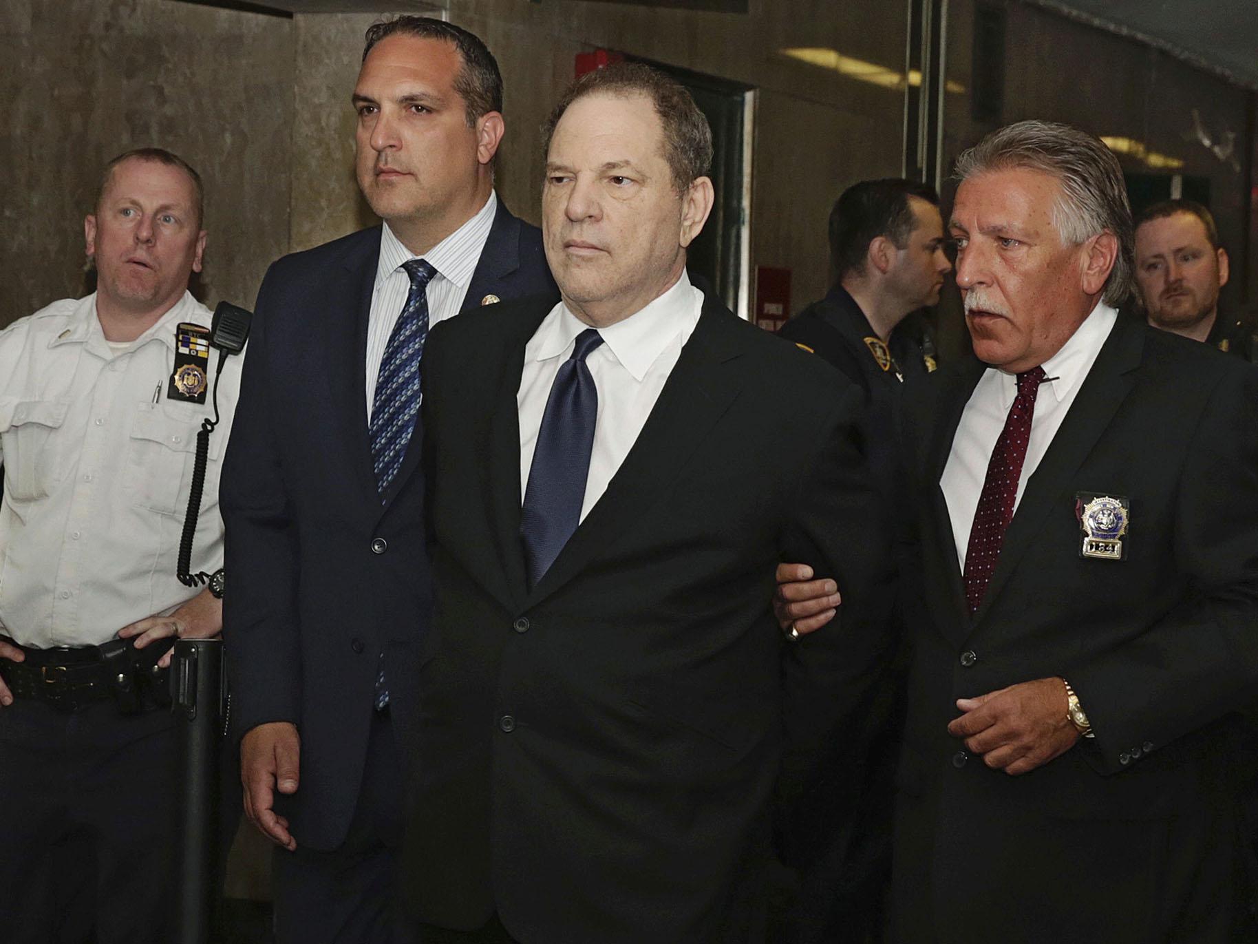 In this July 9, 2018 file photo, Harvey Weinstein is escorted in handcuffs to a courtroom in New York