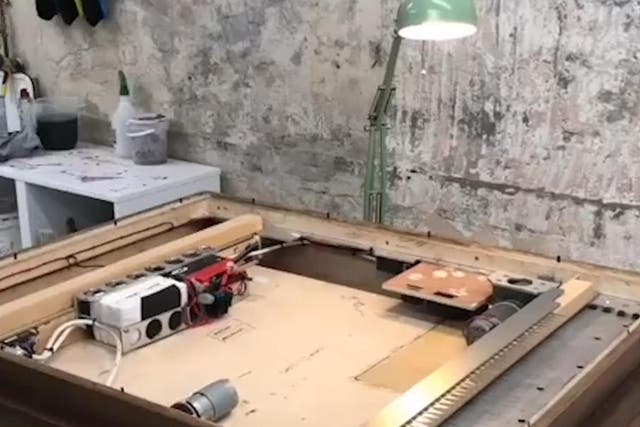 The video posted on Banksy's Instagram account shows the shredder being installed in the frame