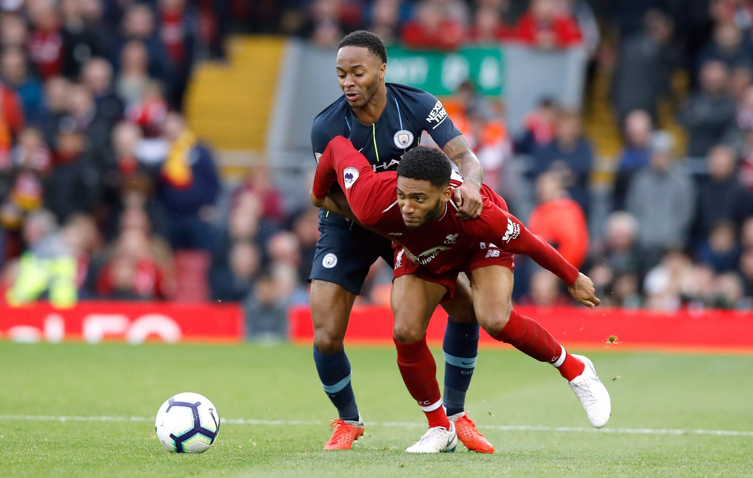 Raheem Sterling and Joe Gomez battle for the ball