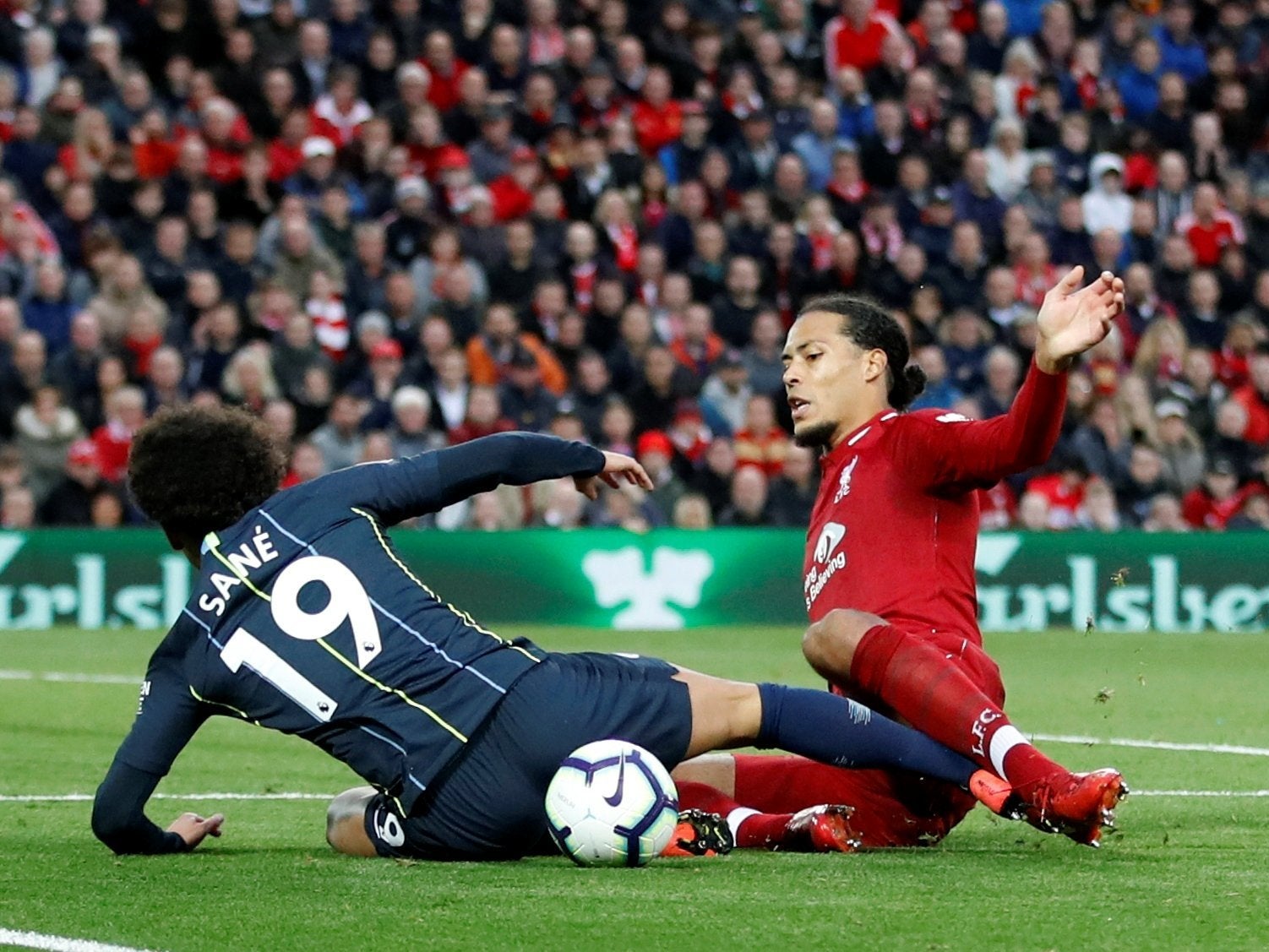 Leroy Sane wins a penalty from Virgil van Dijk’s challenge