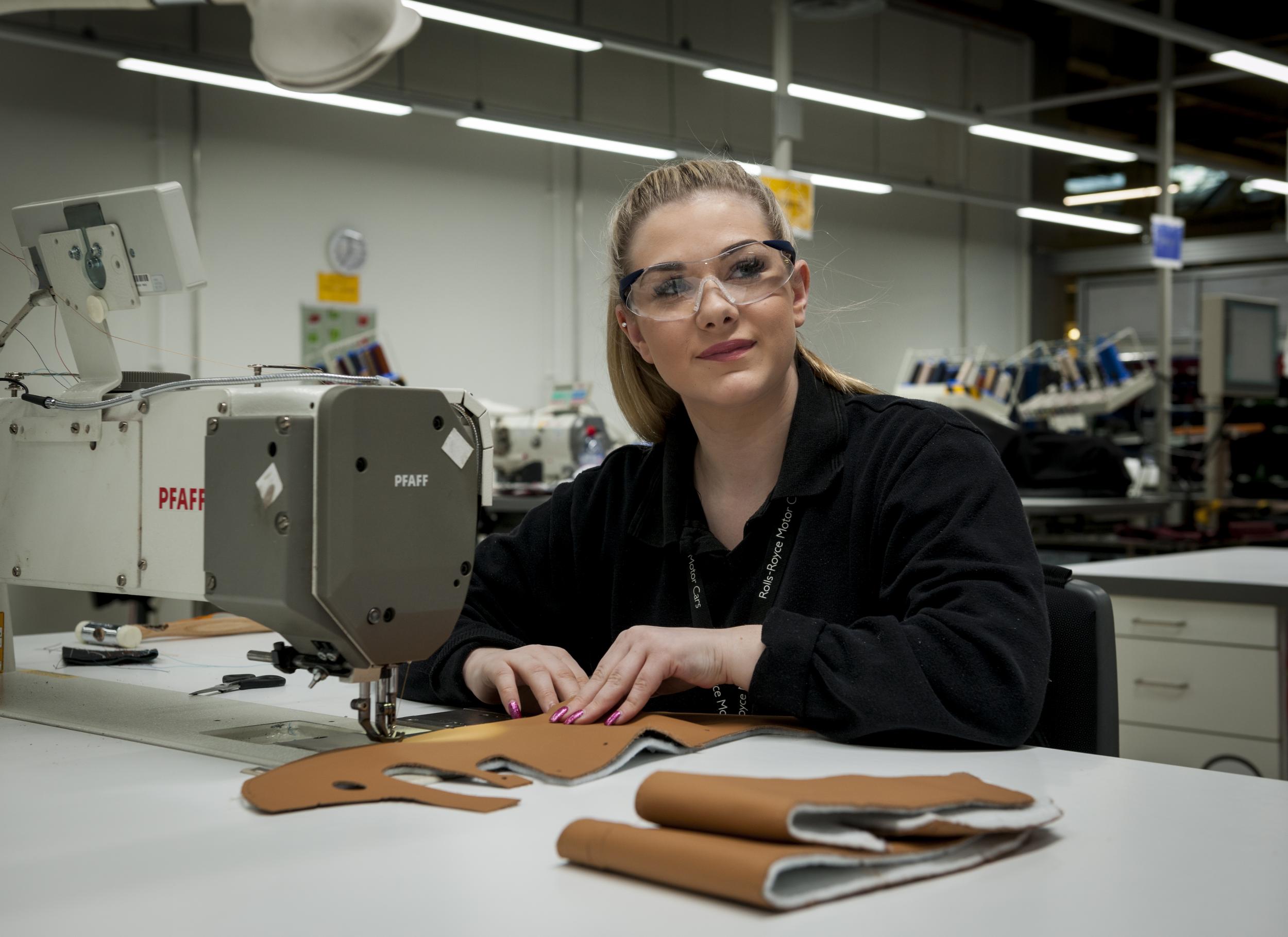 Apprentice Georgia Dickinson learns the craft of leather working