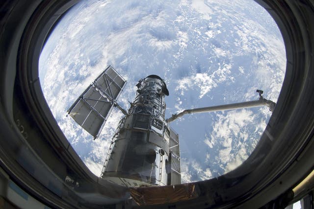 This still photo image taken May 13, 2009 and made available May 14, 2009 shows the Hubble Space Telescope after its' grapple by the space shuttle Atlantis's robot arm