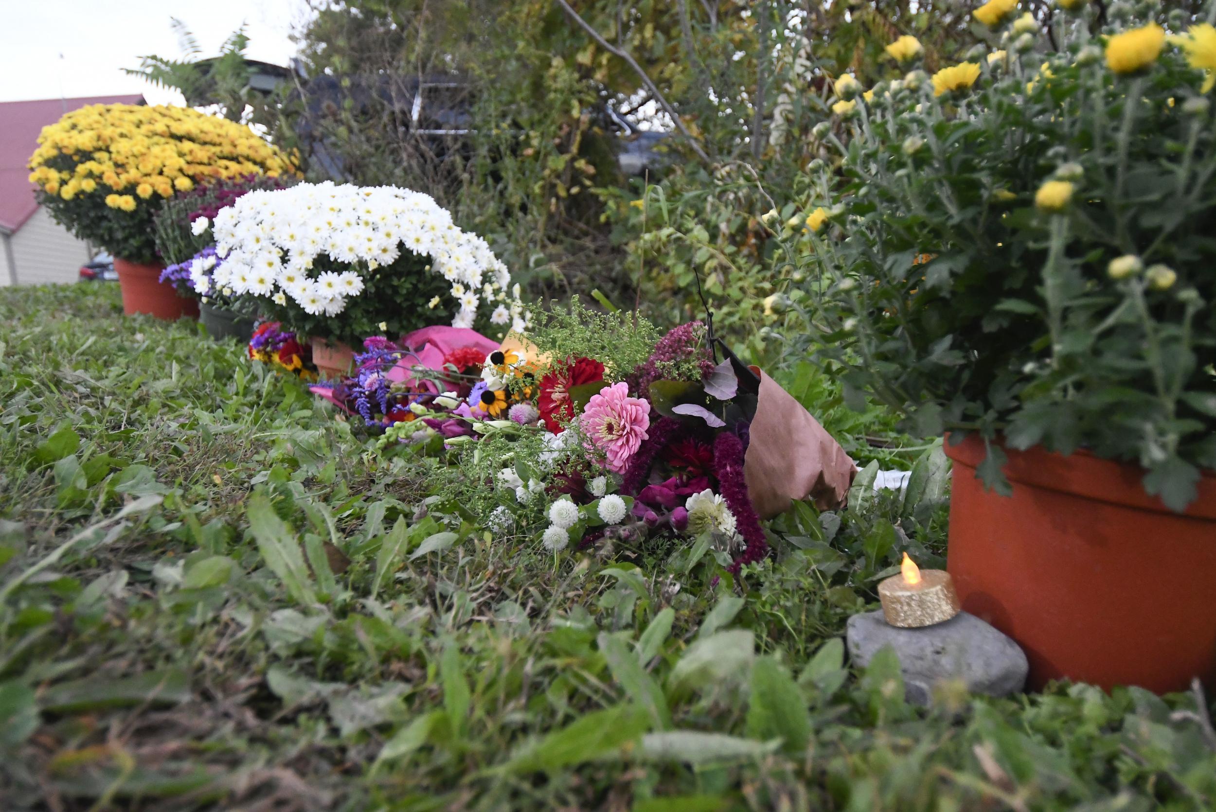 Flowers are placed at a roadside memorial at the scene of the fatal limousine crash which killed 20 people in Schoharie, New York. ( AP Photo/Hans Pennink)