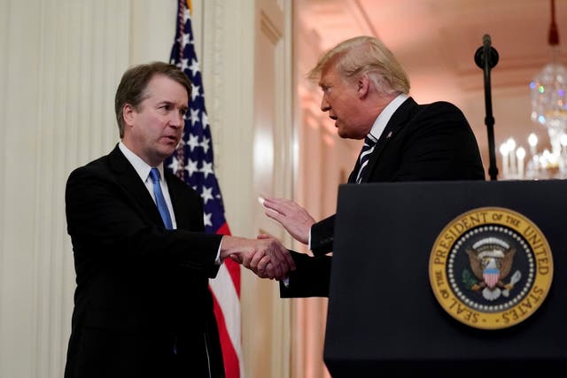 Supreme Court Justice Brett Kavanaugh talks with Donald Trump during his ceremonial swearing in.