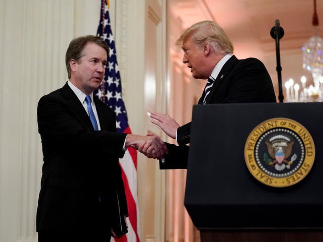 Supreme Court Justice Brett Kavanaugh talks with Donald Trump during his ceremonial swearing in.