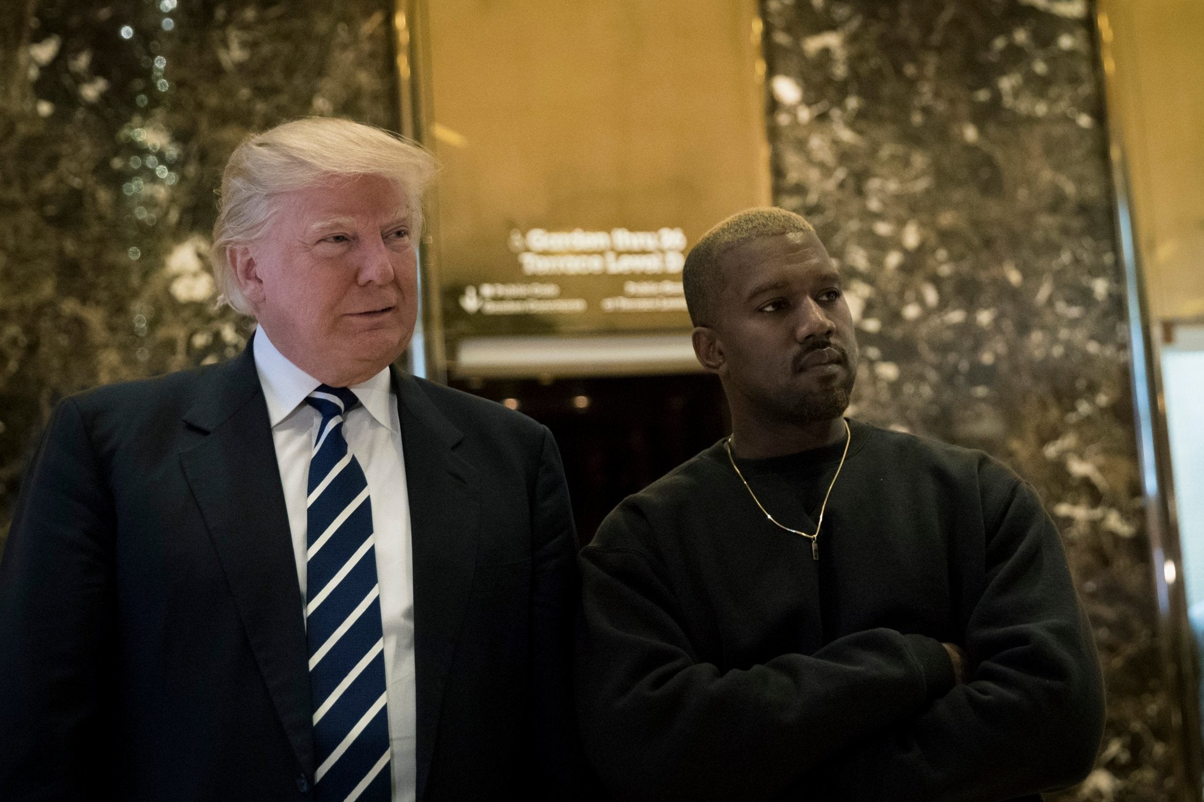 Donald Trump and Kanye West stand together in the lobby at Trump Tower, 13 December, 2016 in New York City
