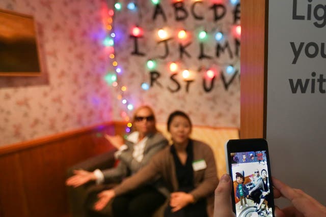 Attendees demo the augmented reality integration of the new Google Pixel 2 smartphone using the demigorgon from Netflix's Stranger Things series at a product launch event