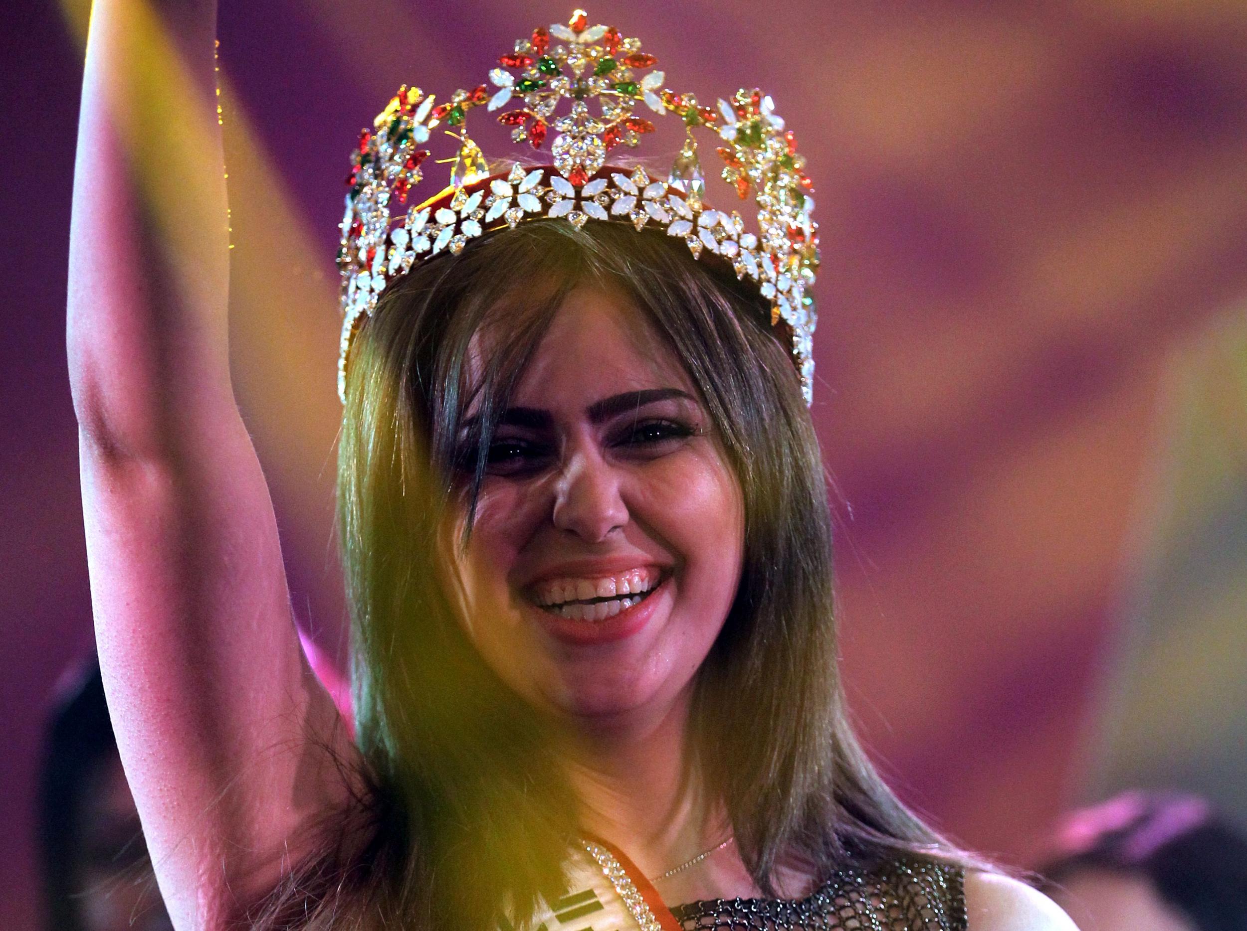 Shaimaa Qasim, from Kirkuk, waves after winning the Miss Iraq beauty contest on December 19, 2015 in the capital Baghdad. Photo: AHMAD AL-RUBAYE/AFP/Getty Images