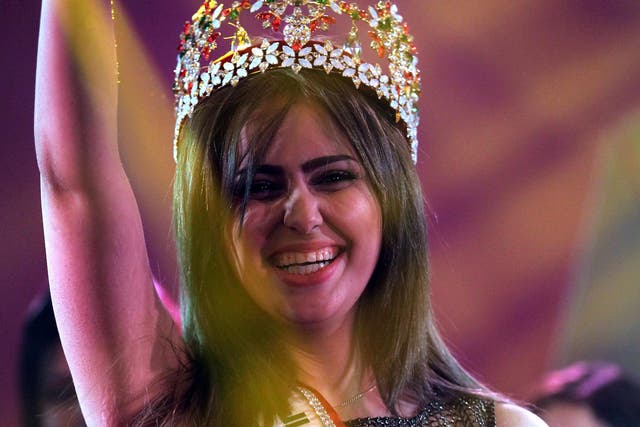 Shaimaa Qasim, from  Kirkuk, waves after winning the Miss Iraq beauty contest on December 19, 2015 in the capital Baghdad.  Photo: AHMAD AL-RUBAYE/AFP/Getty Images