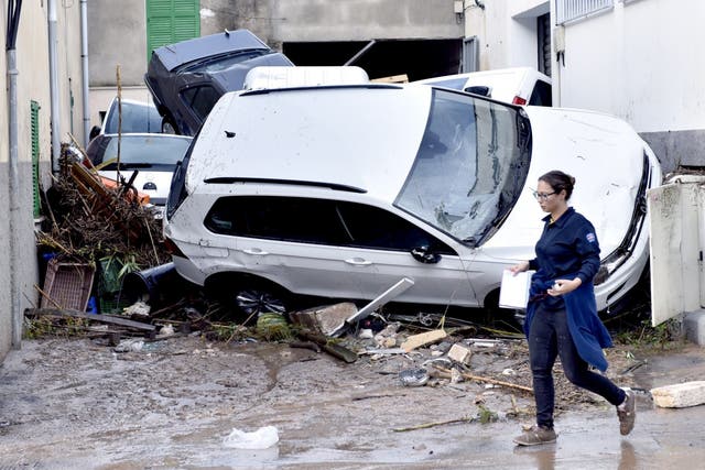 Torrential rain and flash flooding left streets swamped and cars mangled