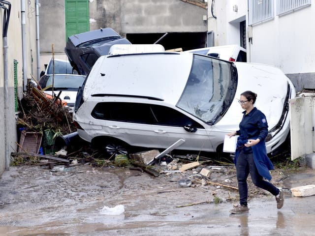 Torrential rain and flash flooding left streets swamped and cars mangled