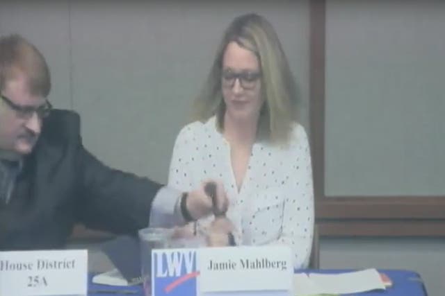 A Minnesota state representative snatched a microphone from his Democrat opponent's hands and dropped it in front of her at a public forum