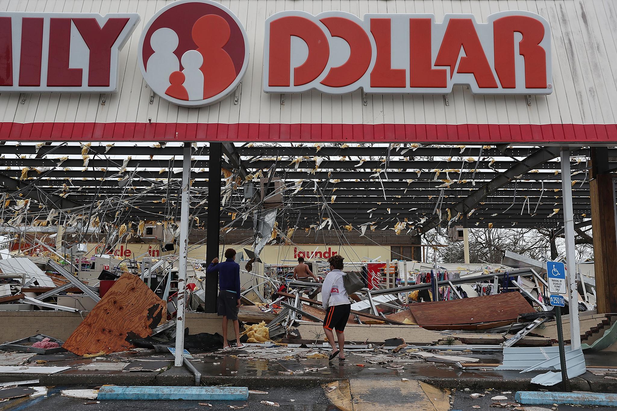 People look on at a damaged store in Panama City