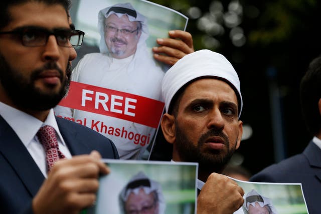 Members of the Turkish-Arab Journalist Association hold posters with photos of missing Saudi writer Jamal Khashoggi, as they hold a protest near the Saudi Arabia consulate in Istanbul