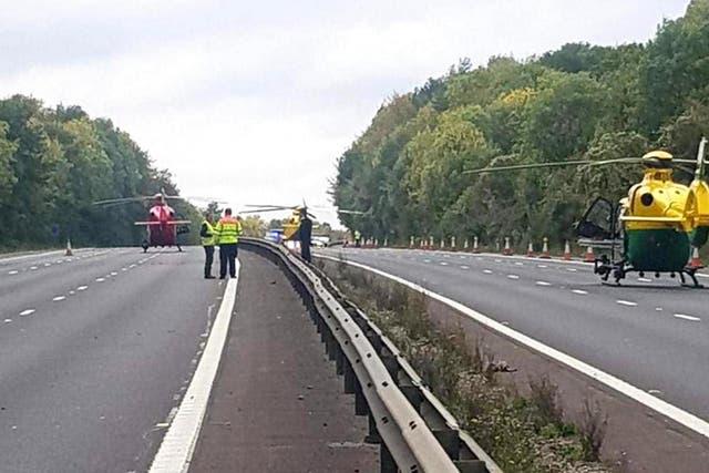 Three Air ambulances pictured on the M4 in Berkshire after a heavy goods vehicle crashed into a minibus