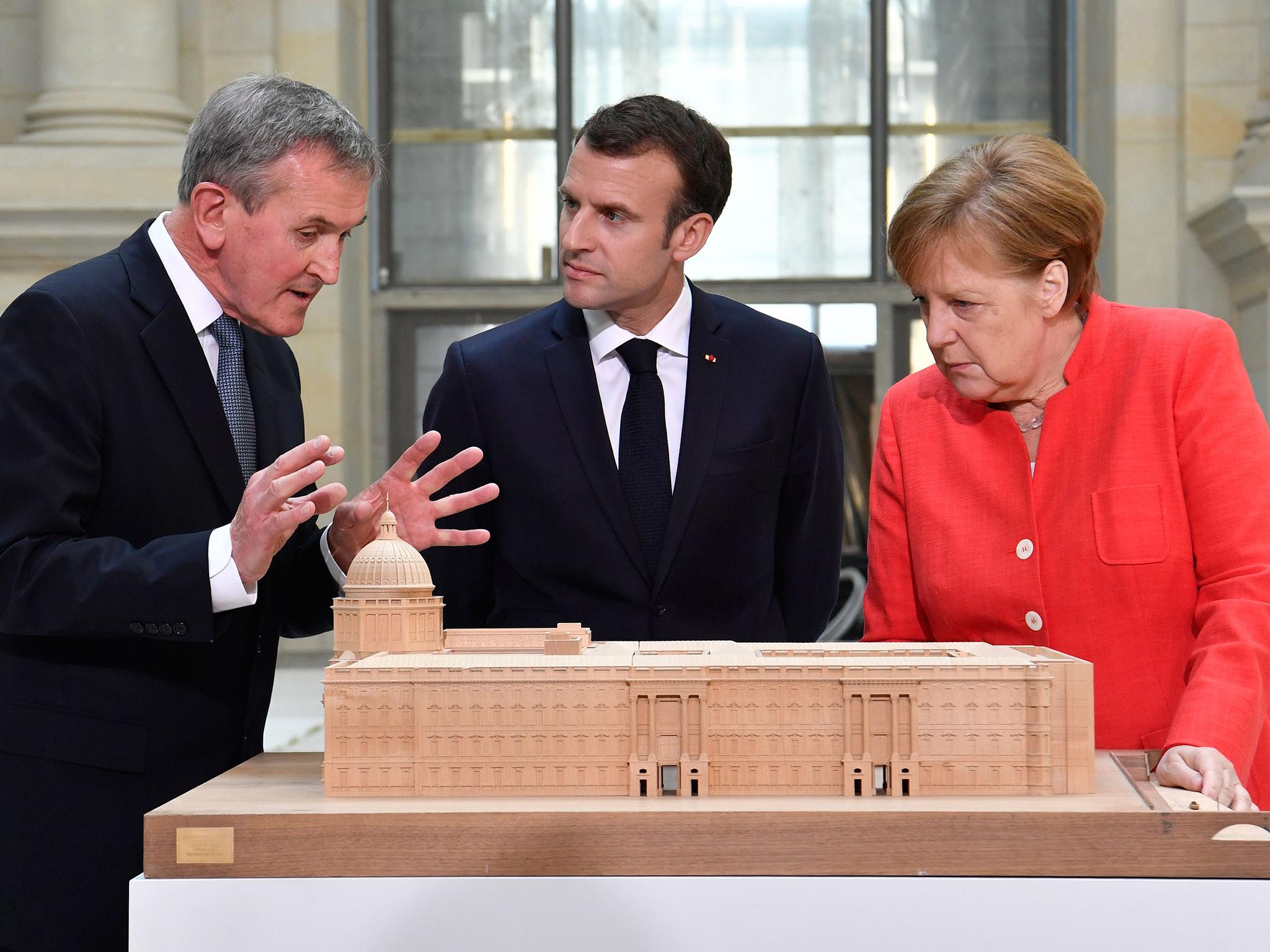 Angela Merkel and Emmanuel Macron get an explanation of the construction