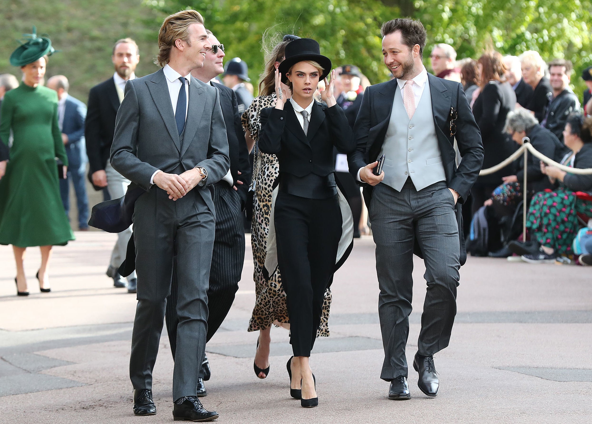 Cara Delevingne arrives at the royal wedding with her brother-in-law James Cook (left) and US journalist Derek Blasberg