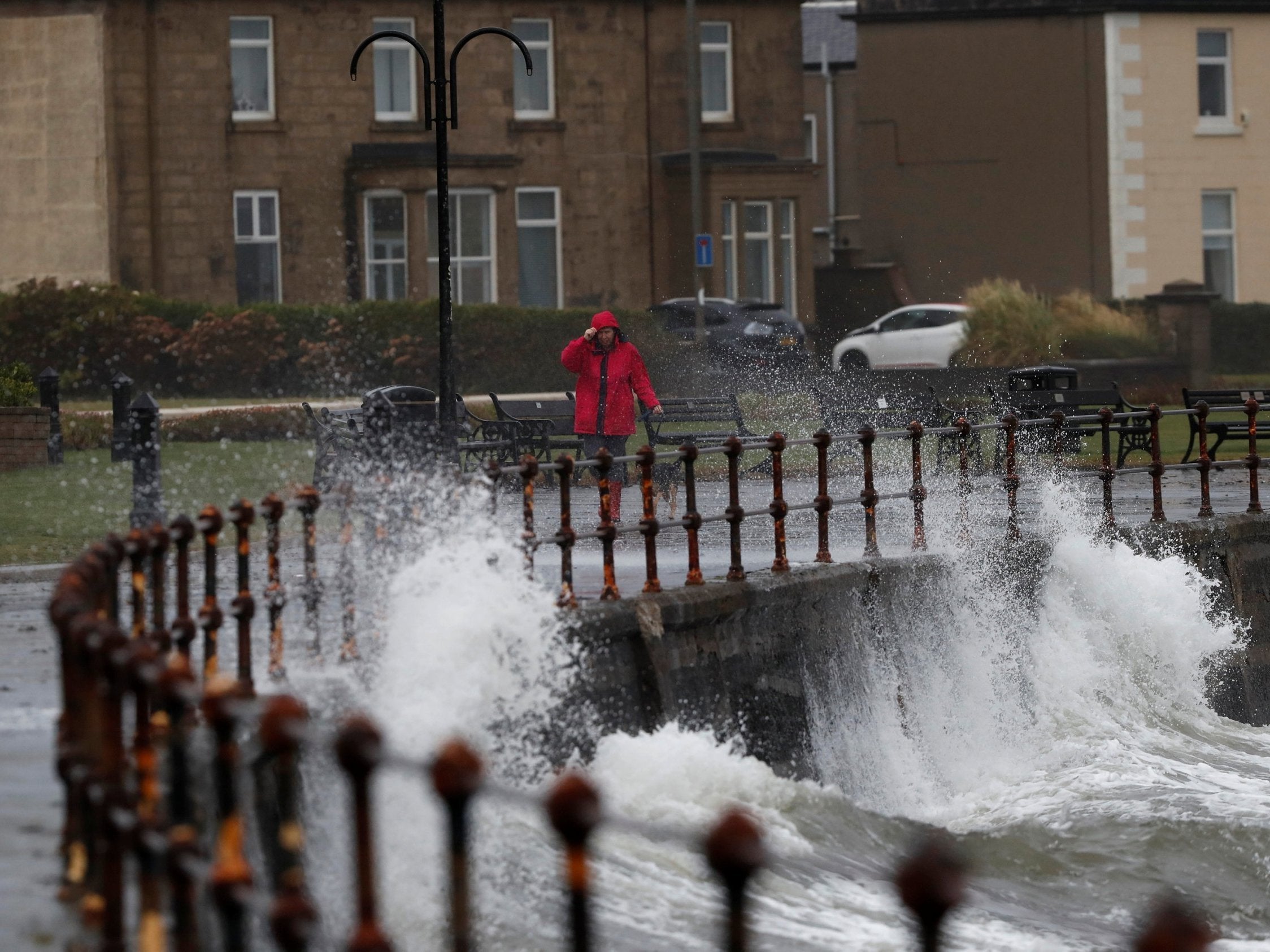 A woman walks her dog in Ardrossan as Storm Callum hits Scotland