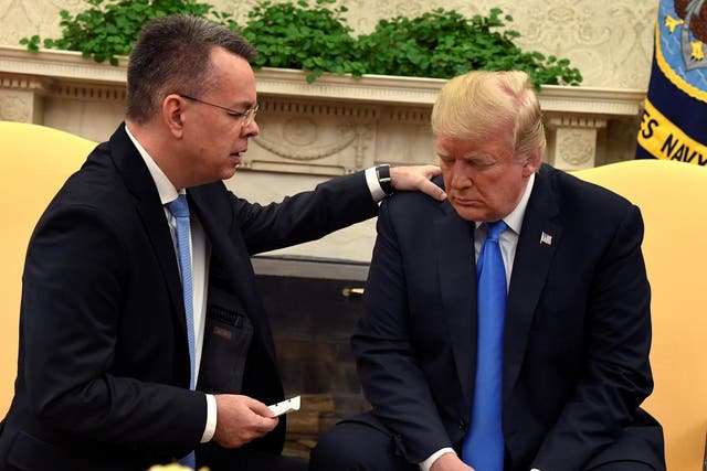Mr Brunson knelt and prayed for Mr Trump in the Oval Office