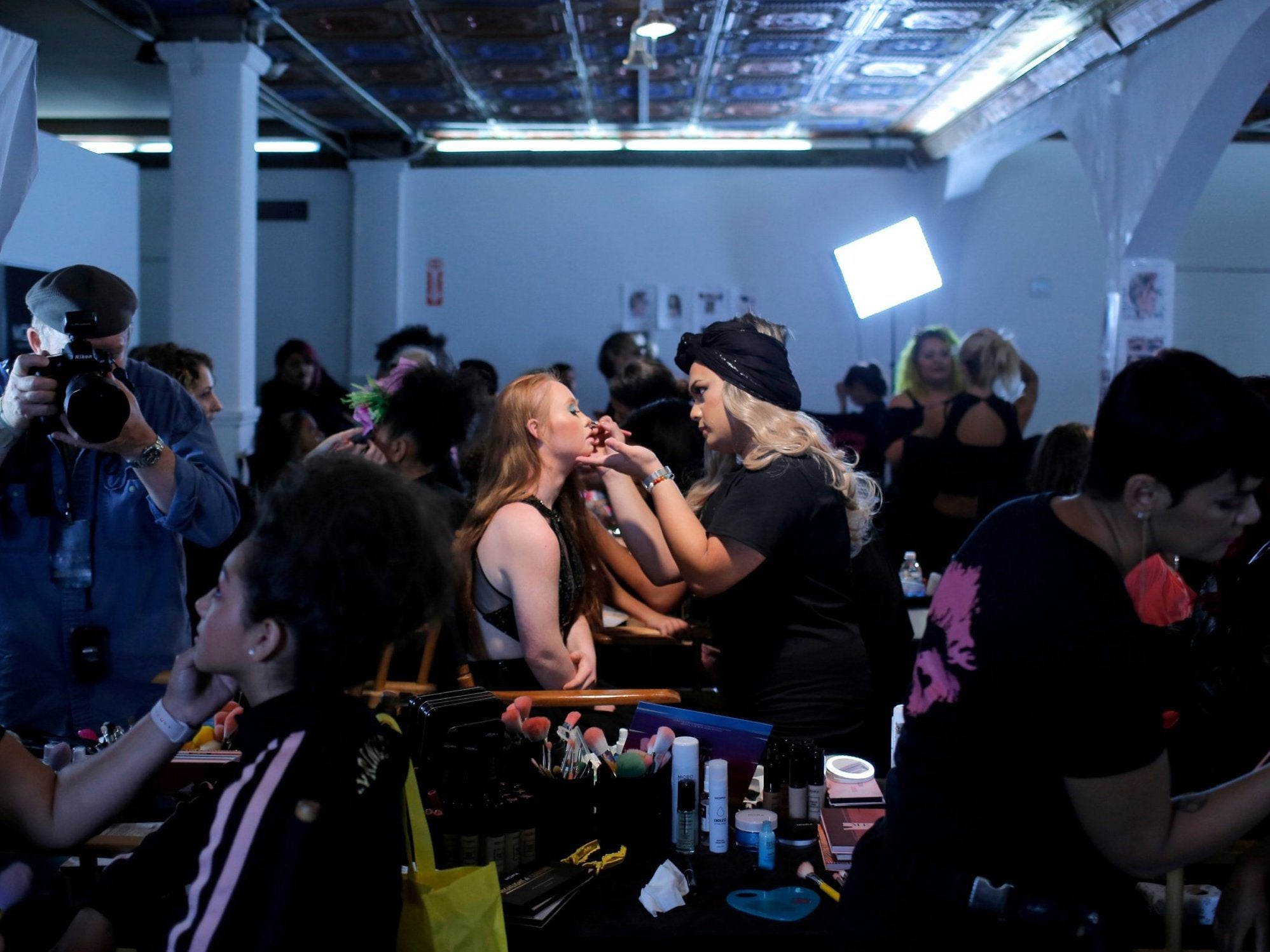 Model Madeline has the finishing touches to her makeup done backstage during New York Fashion Week
