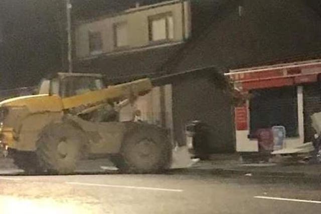 Digger outside Bobby's Newsagents in Forth