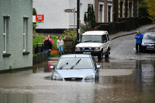 A car is stranded in floodwater in Tonna near Aberdulais, as Wales faces its worst flooding for more than 20 years