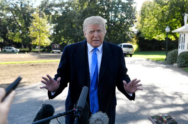 US President Donald Trump speaks to reporters on the South Lawn before boarding Marine One at the White House on October 13, 2018 in Washington, DC