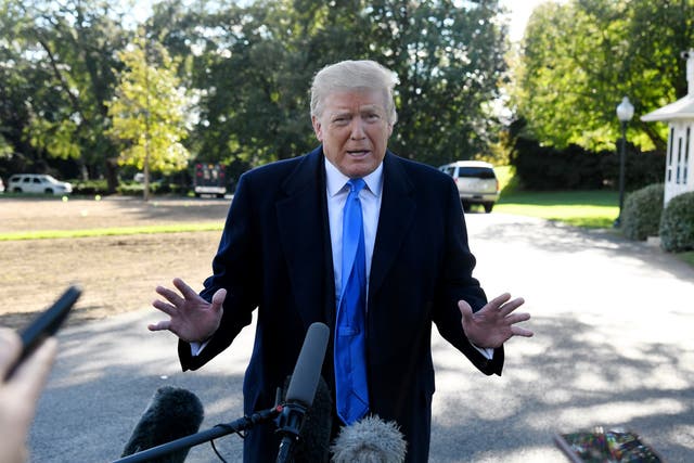 US President Donald Trump speaks to reporters on the South Lawn before boarding Marine One at the White House on October 13, 2018 in Washington, DC