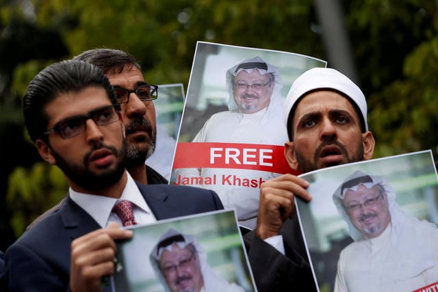 Human rights activists and friends of Saudi journalist Jamal Khashoggi hold his pictures during a protest outside the Saudi Consulate in Istanbul, Turkey