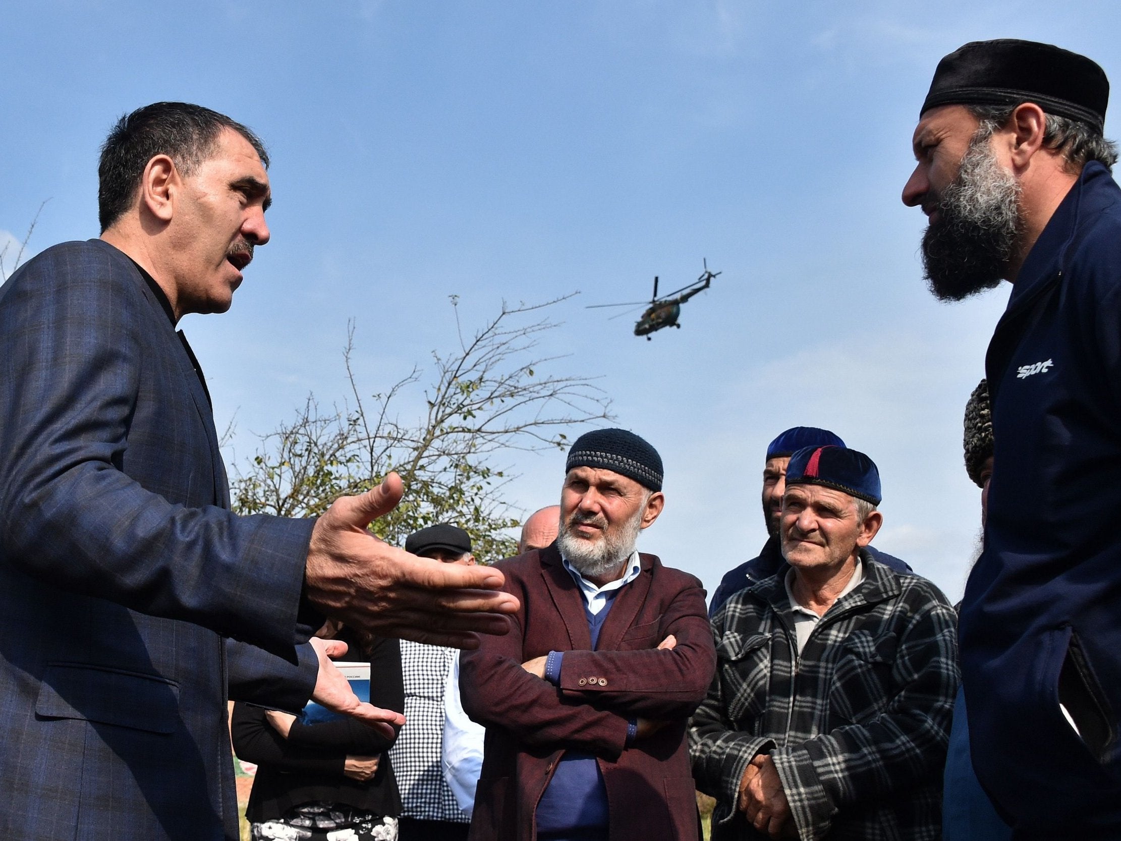 Ingushetia's leader Yunus-Bek Yevkurov, left, speaks to locals in Dattykh, near the new border with Chechnya
