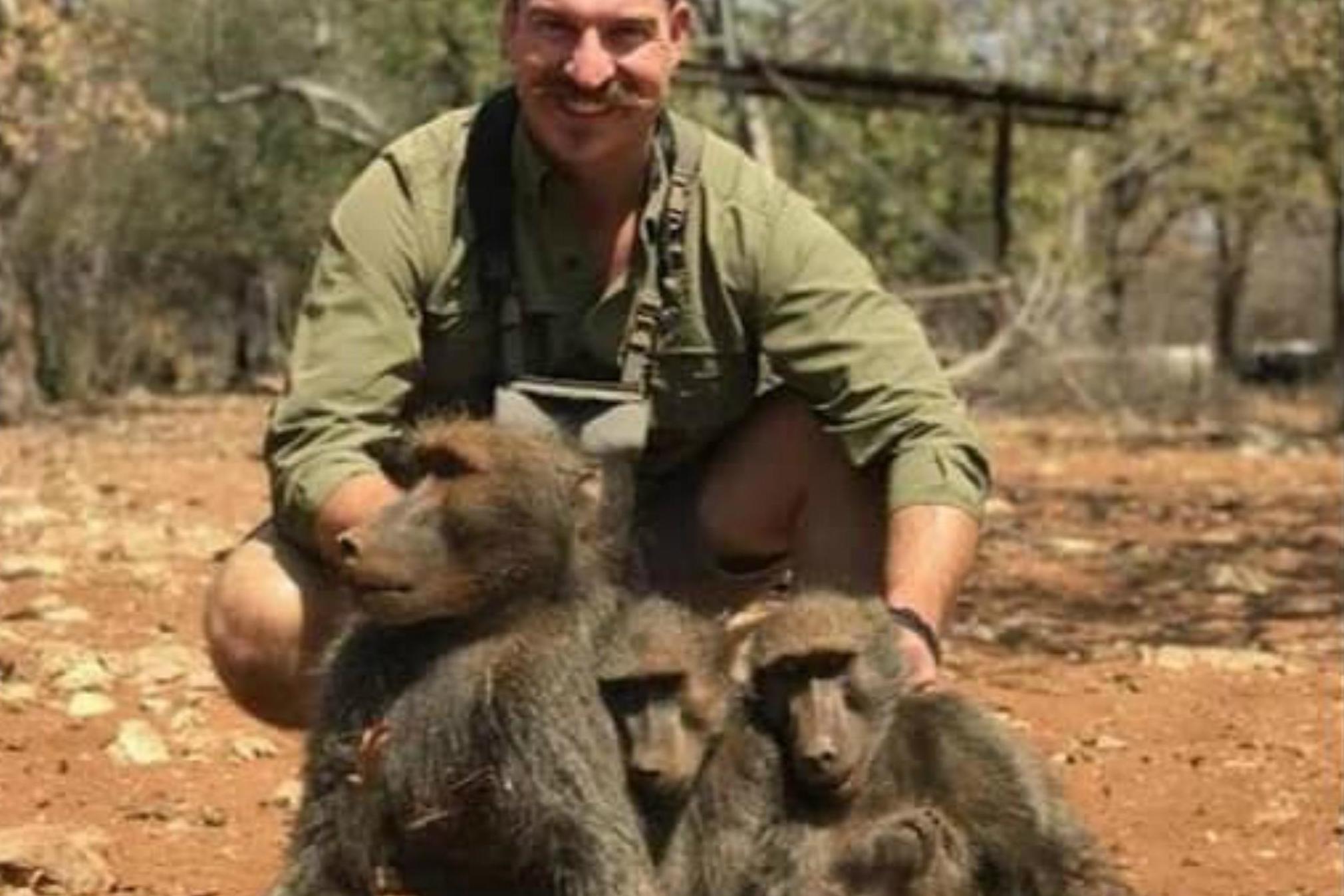 Blake Fischer, an Idaho Fish and Game Commissioner, has been called on to resign after posing for a picture with the family of baboons he killed.