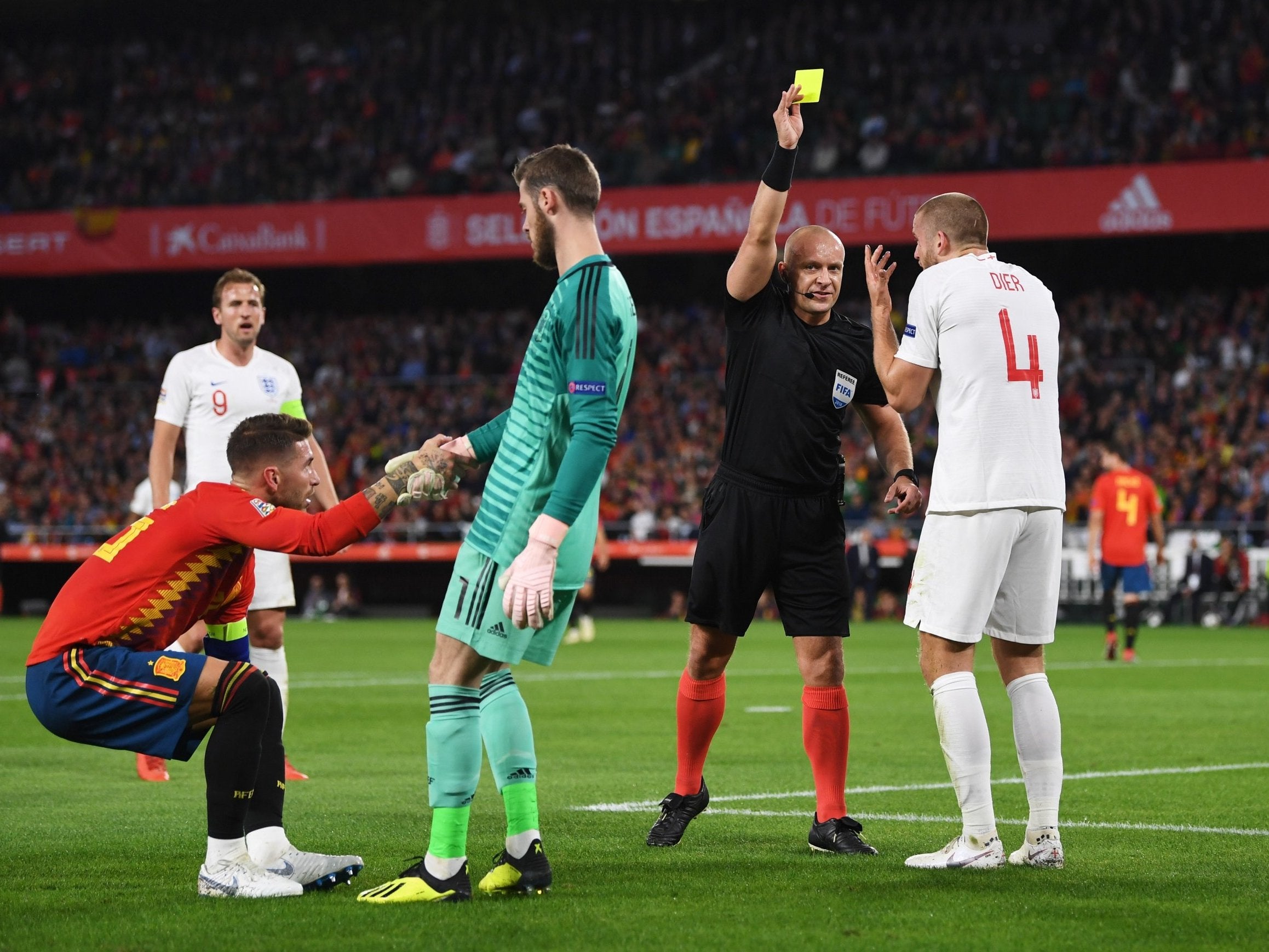 Referee Szymon Marciniak booked Dier for his tackle